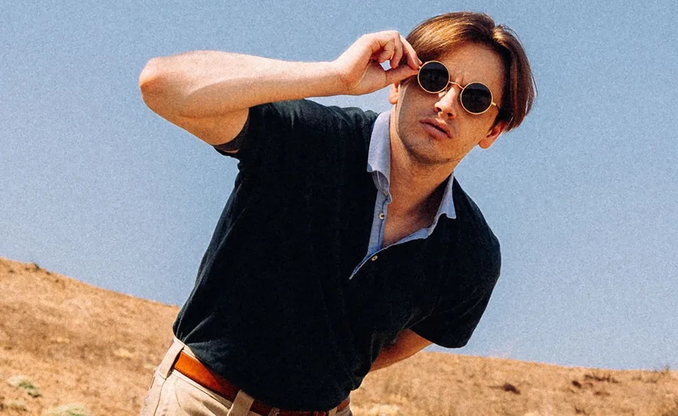 Nikita, The Wicked wearing sunglasses and a dark shirt outdoors.