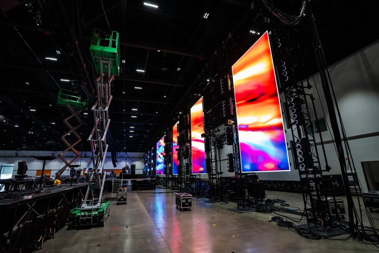 Stage screens and lighting during Give Thanks 2025 production setup.
