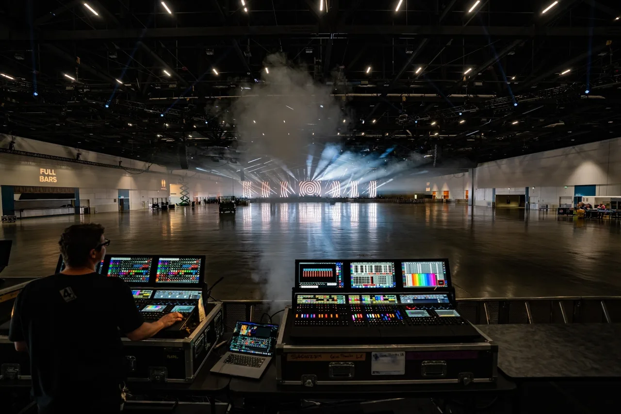 Lighting desks in the empty San Jose Convention Center during Give Thanks 2025 setup.