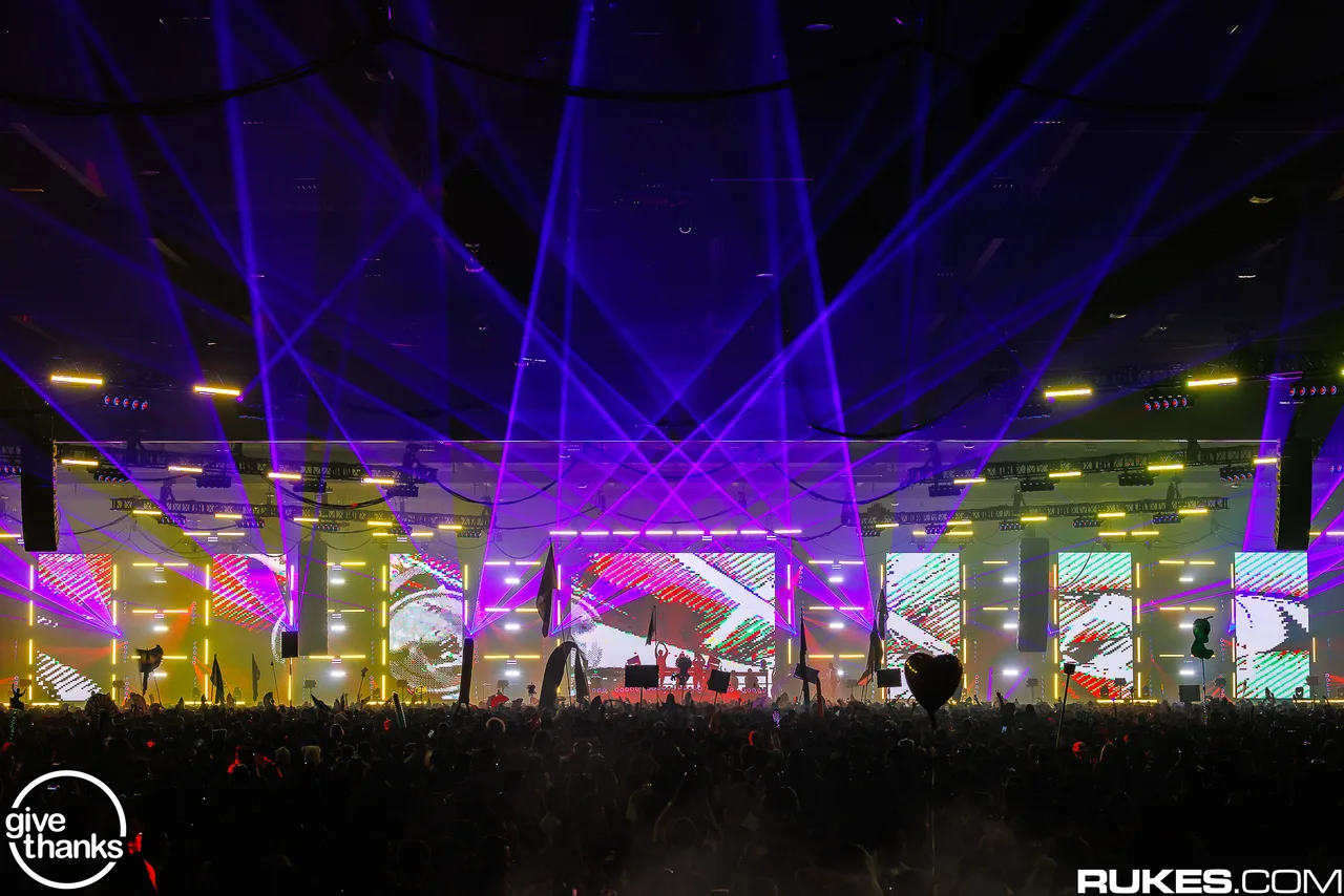 A wide view of the illuminated Give Thanks 2025 stage from the crowd.